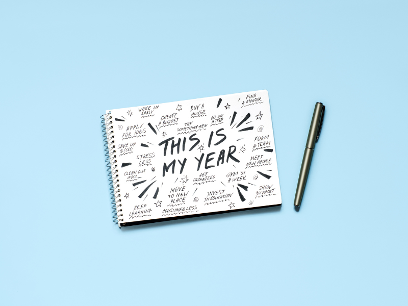 A notepad with handriwting covering the page, of various new year's resolutions