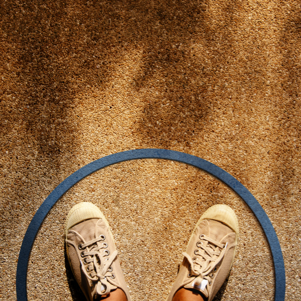A person stands within a circle on a pavement