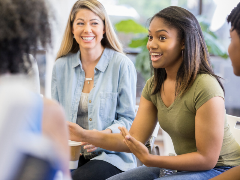 A woman smiles during a support group.