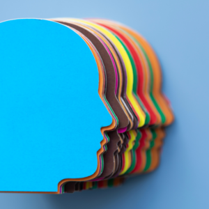 A pile of brightly coloured card overlaps, in the shape of a human head.